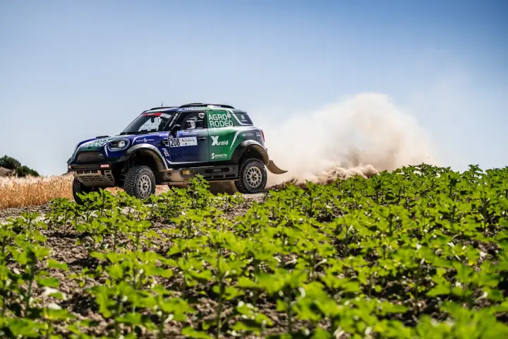 Andalucía Rally 2021: Mini racing past green crop field sunny day