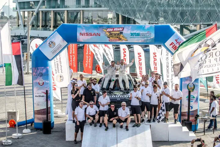 Abu Dhabi Desert Challenge 2018: team celebrating victory under finish arch