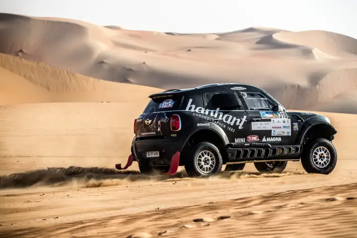 Abu Dhabi Desert Challenge 2018: Mini rear view racing through golden sand dunes