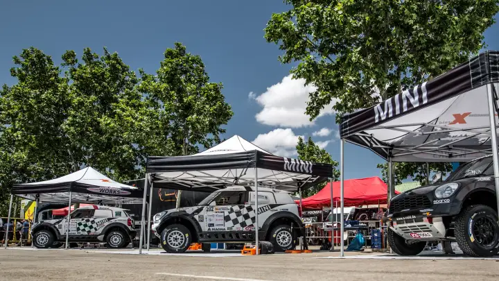 Baja Aragón 2016: multiple Mini rally cars in outdoor paddock area