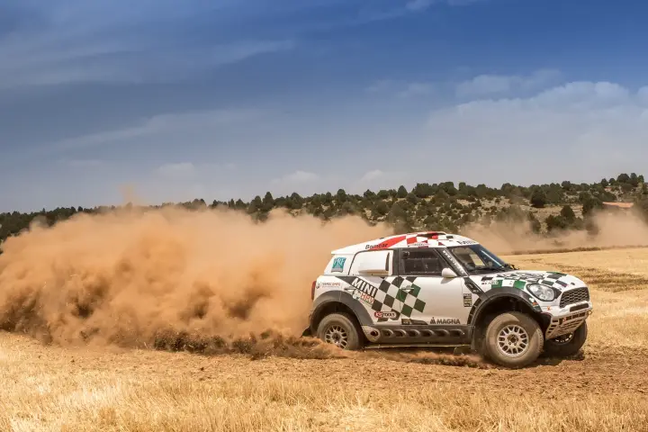 Baja Aragón 2016: Mini rally car drifting on golden dusty terrain