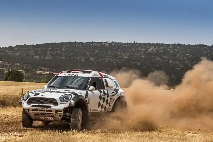 Baja Aragón 2016: Mini rally car speeding on wheat field trail