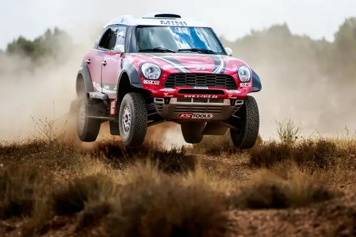 Baja Aragón 2017: red Mini airborne jumping over rough terrain obstacle