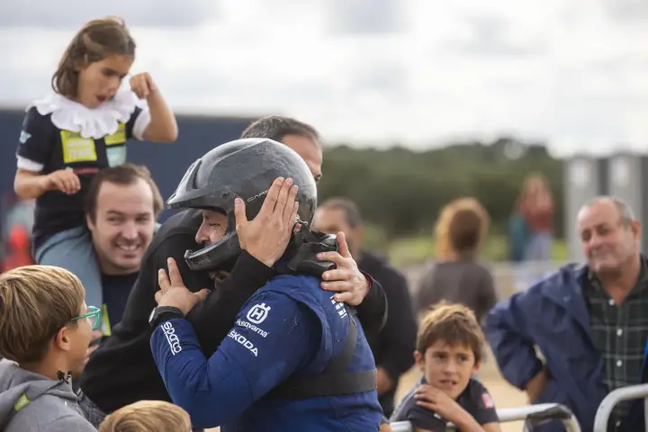Baja Portalegre 500 2024: Helmeted driver embracing child at finish line
