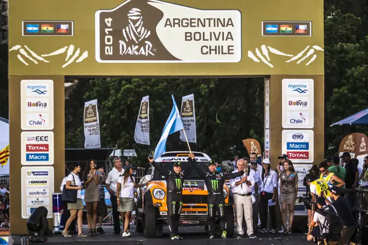 Dakar Rally 2014: Driver waves flag on ceremony stage