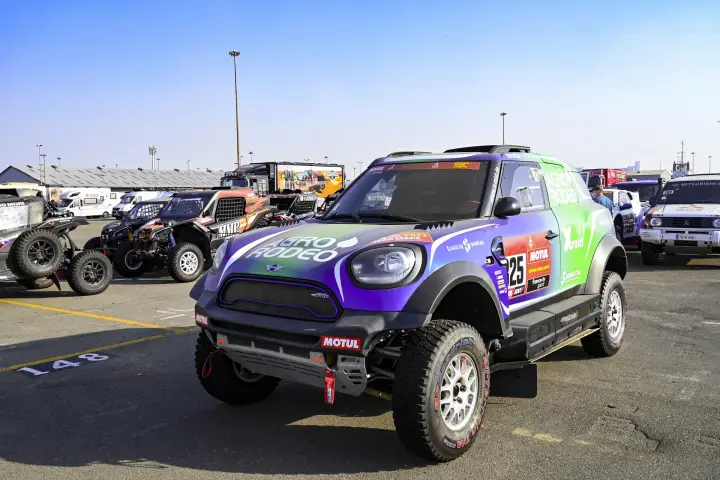 Dakar Rally 2021: blue Mini parked in service park among other cars