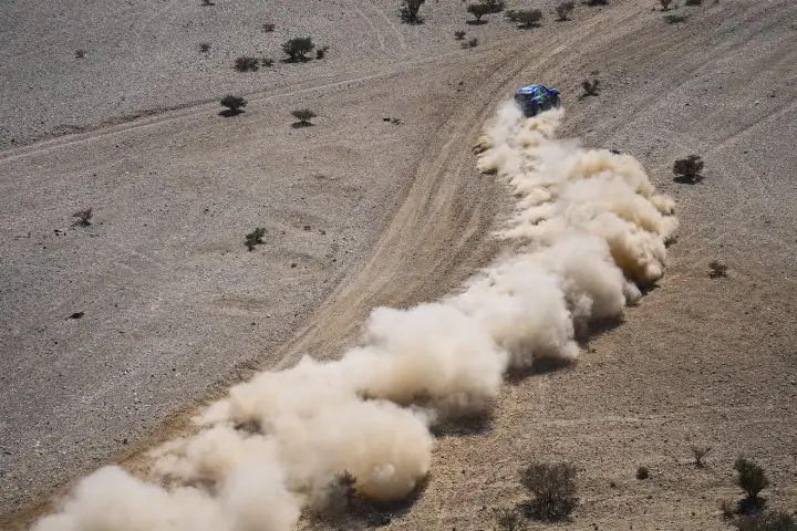 Dakar Rally 2021: aerial view Mini leaving long dust trail in desert
