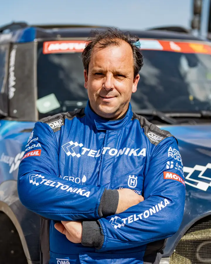 Dakar Rally 2022: driver portrait arms crossed race suit outdoors