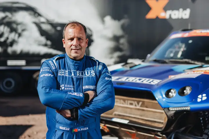 Dakar Rally 2024: co-driver P. Fiuza portrait arms crossed before car