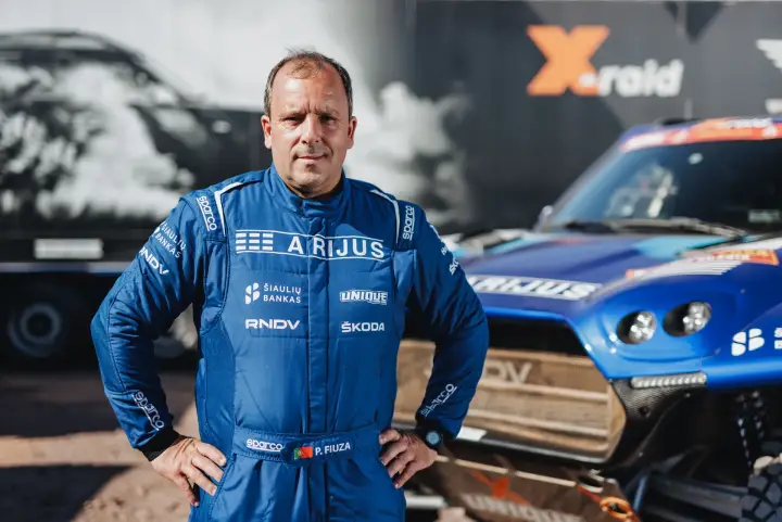 Dakar Rally 2024: co-driver serious portrait standing before race car