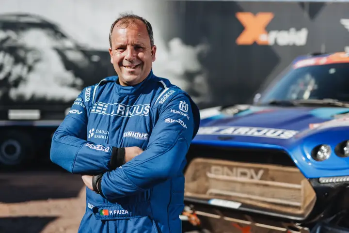 Dakar Rally 2024: co-driver smiling portrait arms crossed X-raid backdrop