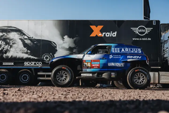 Dakar Rally 2024: Arijus buggy on trailer beside X-raid team truck