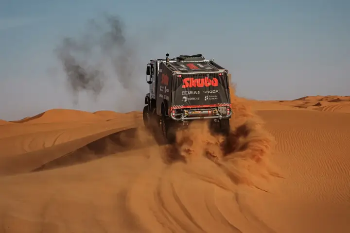 Dakar Rally 2025: Skuba truck rear view on sandy dune with exhaust smoke