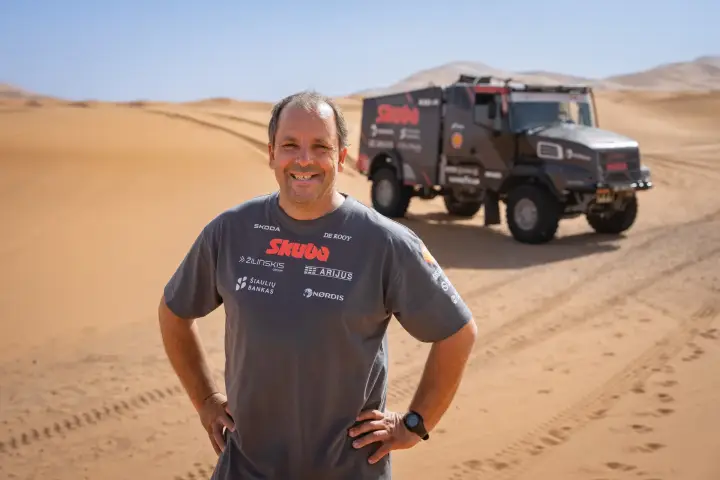 Dakar Rally 2025: smiling driver portrait Skuba team shirt desert truck