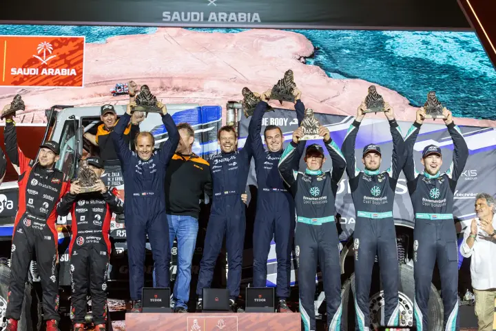 Dakar Rally 2026: Full podium group holding trophies at ceremony