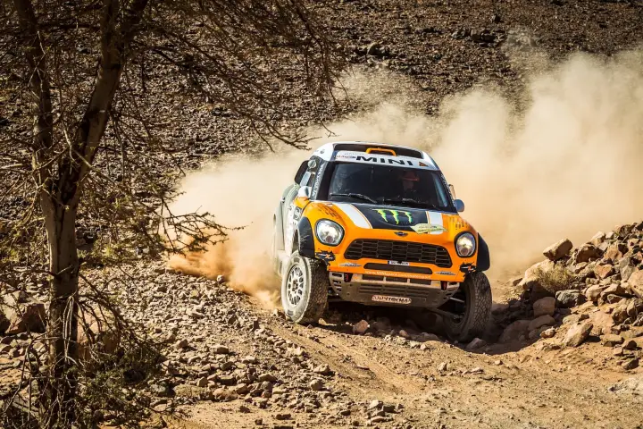 Rallye du Maroc 2013: orange Mini racing through rocky Moroccan river bed