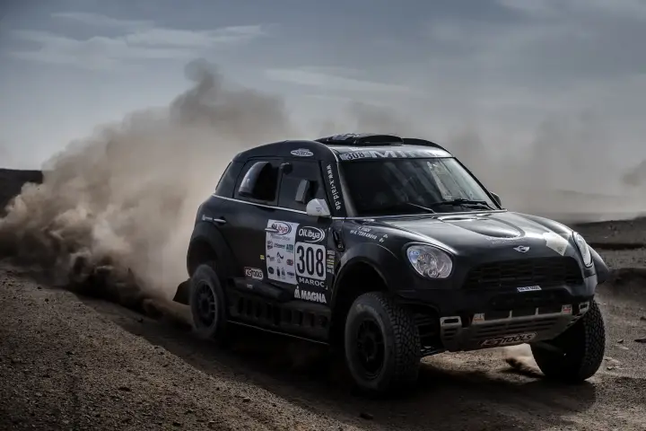 Rallye du Maroc 2016: black Mini cornering through rocky Moroccan desert trail